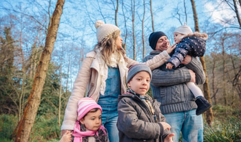 Happy family enjoying together leisure in the forest