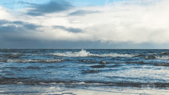 water and sky with small waves during a cloudy day