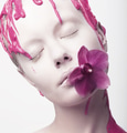 Painted Woman's Face with Pink Flower in her Mouth - PhotoDune Item for Sale
