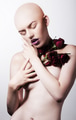 Studio shot of naked hairless woman with roses - PhotoDune Item for Sale