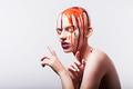 Studio shot of hairless woman with paint on head - PhotoDune Item for Sale