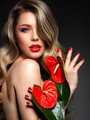 Beautiful blonde with red flowers covers her bare breasts. Portrait of a long-haired blonde - PhotoDune Item for Sale