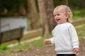 Happy kid playing outside on a spring day. Adorable child walking in a garden and laughing. - PhotoDune Item for Sale