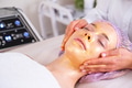 Cosmetologist applies a woman a therapeutic mask on her face. - PhotoDune Item for Sale