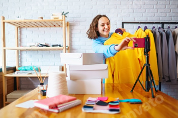 Female warehouse worker, seller, dropshipping small business owner recording new content for vlog.