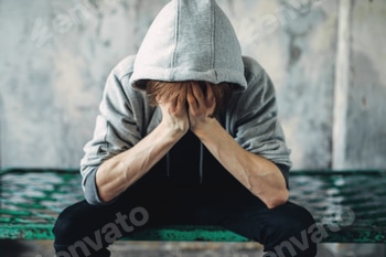Junkie sitting on the bed, withdrawal symptom