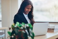 Smiling African American businesswoman working at an office table - PhotoDune Item for Sale