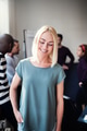 Smiling designer standing in an office with colleagues behind her - PhotoDune Item for Sale