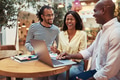 Laughing businesspeople working on a laptop in an office lounge - PhotoDune Item for Sale