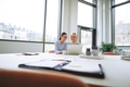 Two smiling businesswomen sitting in an office using a laptop - PhotoDune Item for Sale