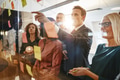 Businessman brainstorming with his diverse staff on a glass wall - PhotoDune Item for Sale