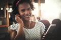 Smiling young African woman listening to music during her commute - PhotoDune Item for Sale
