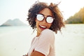 Laughing woman standing on a tropical beach during vacation - PhotoDune Item for Sale