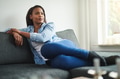 Content young African woman relaxing on her sofa at home - PhotoDune Item for Sale