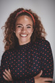 Smiling female entrepreneur standing against a gray background - PhotoDune Item for Sale