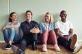 Diverse group of laughing businesspeople sitting on an office floor - PhotoDune Item for Sale