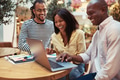 Laughing businesspeople sitting in an office lounge using a laptop - PhotoDune Item for Sale
