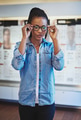Cute young woman trying on new eyeglasses - PhotoDune Item for Sale