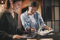 Smiling businesswomen working together on laptop in an office - PhotoDune Item for Sale