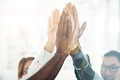 Diverse businesspeople high fiving together in an office - PhotoDune Item for Sale