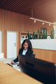 Smiling African American businesswoman sorting paperwork at a reception desk - PhotoDune Item for Sale