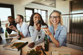 Two laughing businesswomen having pizza and beers after work - PhotoDune Item for Sale