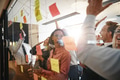 Cheering group of businesspeople high fiving together in an office - PhotoDune Item for Sale