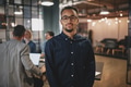 Confident young businessman standing in a modern office - PhotoDune Item for Sale