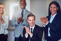 Businesspeople smiling and clapping together after an office presentation - PhotoDune Item for Sale