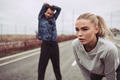 Young woman and her boyfriend preparing for a run together - PhotoDune Item for Sale