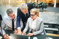 Mature manager and two colleagues working together over a laptop - PhotoDune Item for Sale