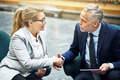 Mature business colleagues shaking hands together in an office lobby - PhotoDune Item for Sale