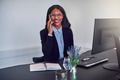Young African American businesswoman talking on her cellphone at work - PhotoDune Item for Sale
