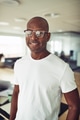 Casually dressed African businessman smiling confidently in an office - PhotoDune Item for Sale