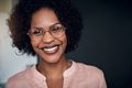 African businesswoman standing in a modern office smiling confidently - PhotoDune Item for Sale