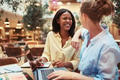 Two laughing young businesswomen working on a laptop together - PhotoDune Item for Sale
