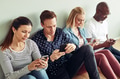 Businesspeople sitting on an office floor using their cellphones - PhotoDune Item for Sale
