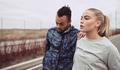 Young couple stretching before jogging along a country road - PhotoDune Item for Sale