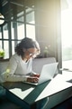 Smiling young African woman working online with a laptop - PhotoDune Item for Sale