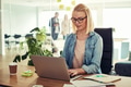 Young businesswoman working on a laptop in an office - PhotoDune Item for Sale