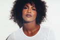 Attractive African woman with attitude standing against a white background - PhotoDune Item for Sale