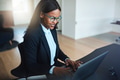 Smiling African American businesswoman working in her office - PhotoDune Item for Sale