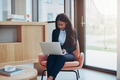 Young African American businesswoman working alone in an office lounge - PhotoDune Item for Sale
