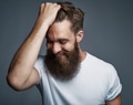 Laughing bearded man holding hair and laughing - PhotoDune Item for Sale