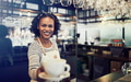 Young African barista offering up a fresh cup of coffee - PhotoDune Item for Sale