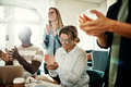 Laughing group of diverse colleagues clapping during an office meeting - PhotoDune Item for Sale