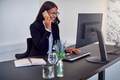 Smiling African American businesswoman talking on her cellphone at work - PhotoDune Item for Sale