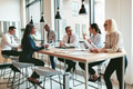 Diverse group of businesspeople talking together around an office table - PhotoDune Item for Sale