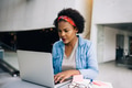 Focused young African female entrepreneur working on a laptop - PhotoDune Item for Sale