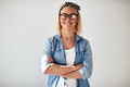 Smiling entrepreneur standing with arms crossed against a white background - PhotoDune Item for Sale